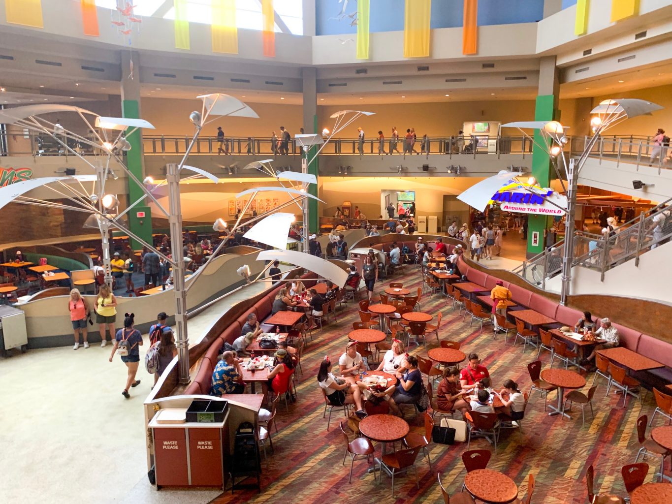 people eating a tables in large sunshine season epcot quick service restaurant