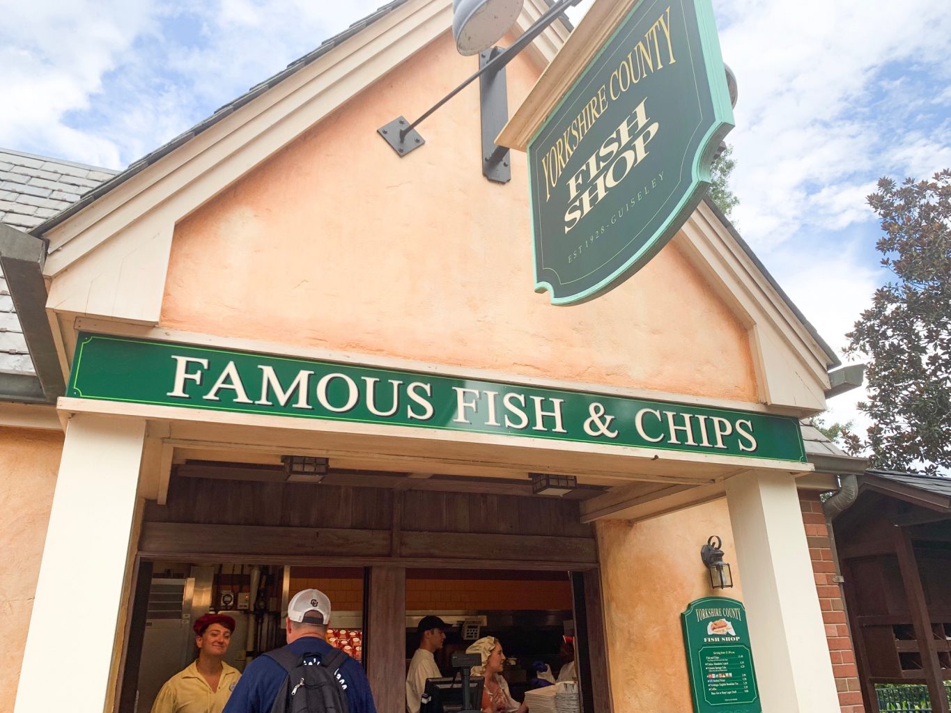 green fish and chips sign on building epcot quick service