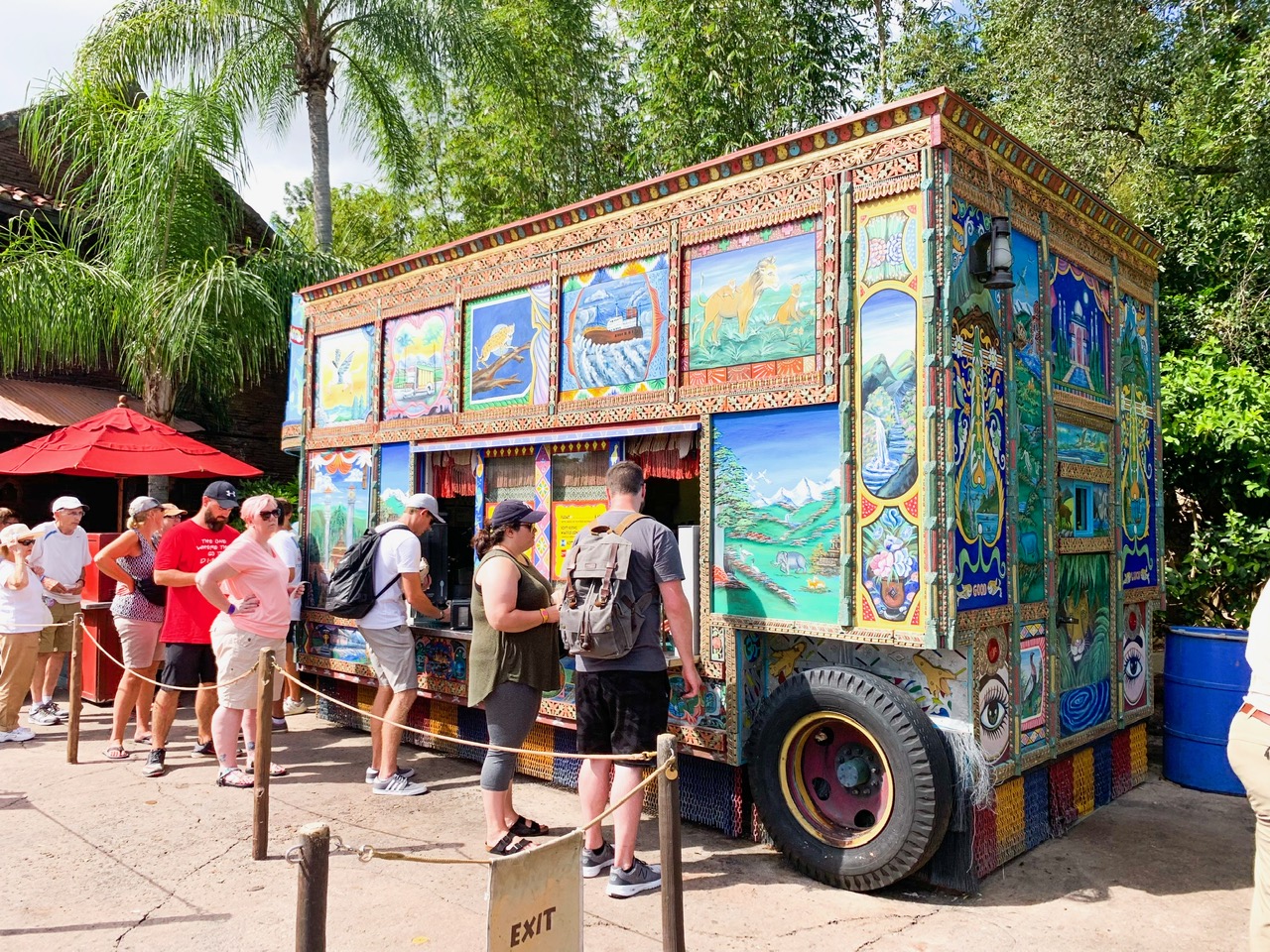 people in line at a blue and colorful painted truck quick service at animal kingdom
