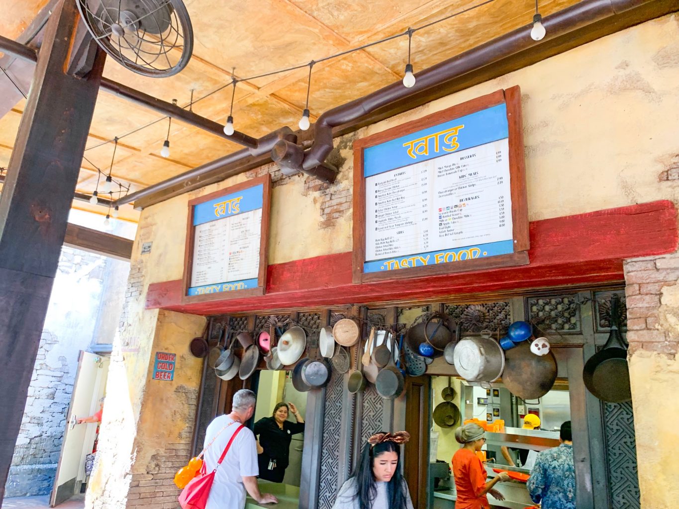 The outdoor ordering area of Yak and Yeti Café are filled with hanging pots and pans, helping create ambiance at one of the best Animal Kingdom restaurants that is also quick service. 