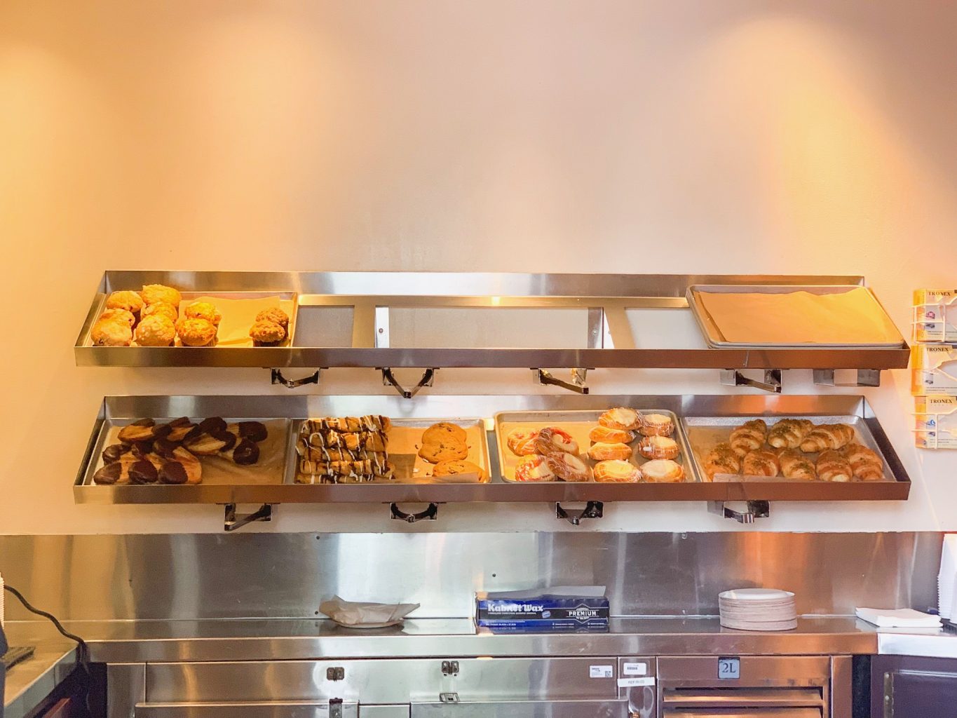 Two shelves of assorted pastries are featured at one of the best Animal Kingdom restaurants, Kusafiri, which features lots of coffee and baked goods!