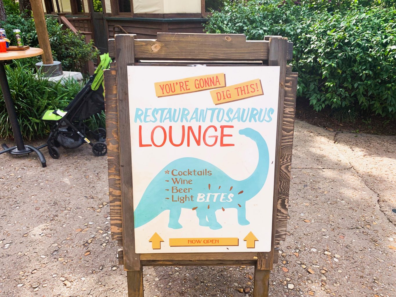 The sign for restaurantosaurus features blue dinosaur outline and lists some of the foods and drinks you can have here. It is far from one of the best Animal Kingdom restaurants, despite its cute advertising. 