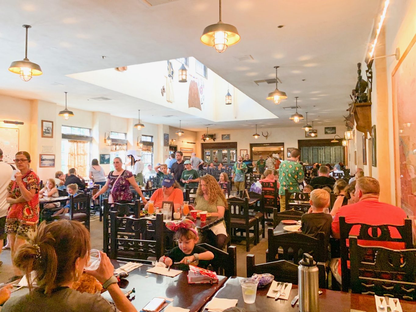 This bustling restaurant with black chairs, buffet style set up and open lighting is tusker's House! It is one of the best Animal Kingdom restaurants, especially if you get to eat their breakfast! 