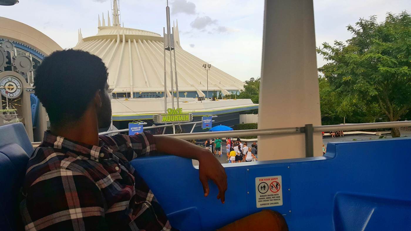 On the Tomorrowland Transit Authority PeopleMover, relaxing as he rides one of the best Magic Kingdom rides.