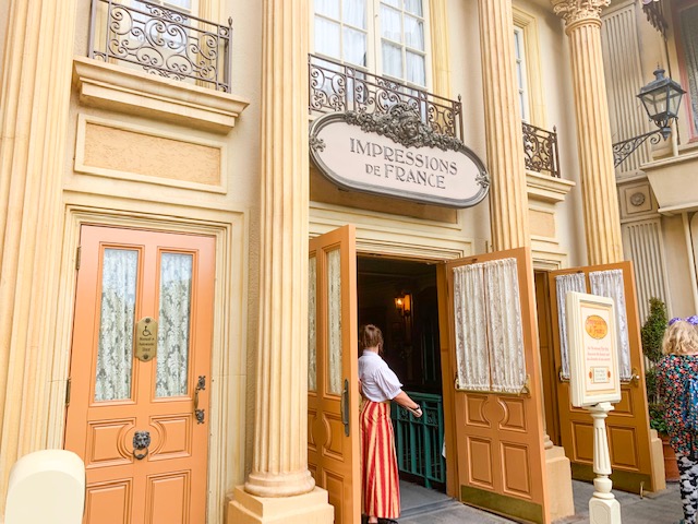 France Pavilion entry to Impressions de France with door open and cast member inviting in guests