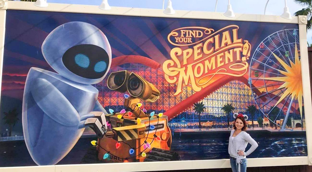 Photo in front of Walle and Eve poster on Boardwalk at Pixar Pier in California Adventure