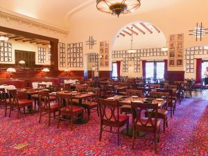 empty dining room with vintage decor and caricatures on the walls