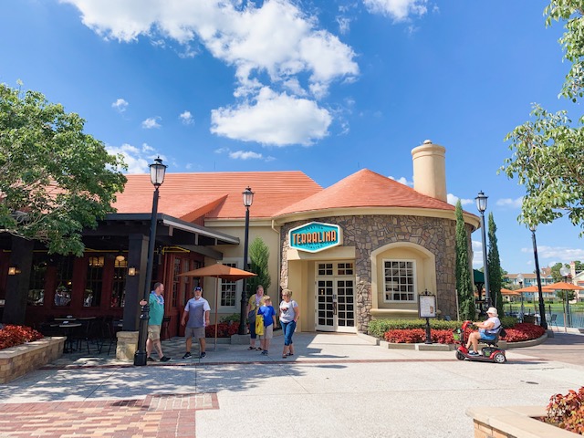 small brick and stone building with people outside