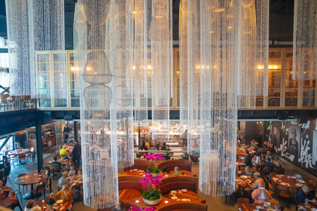 hanging long white chandeliers over tables and chairs