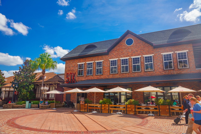 large brick building with tables and chairs outside