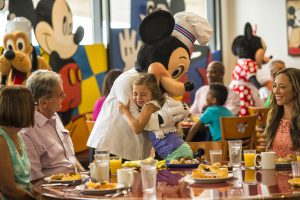 Mickey hugging little girl Disney character dining