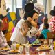 Mickey hugging little girl Disney character dining