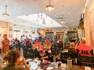 crowded dining room with people eating character dining at Disney