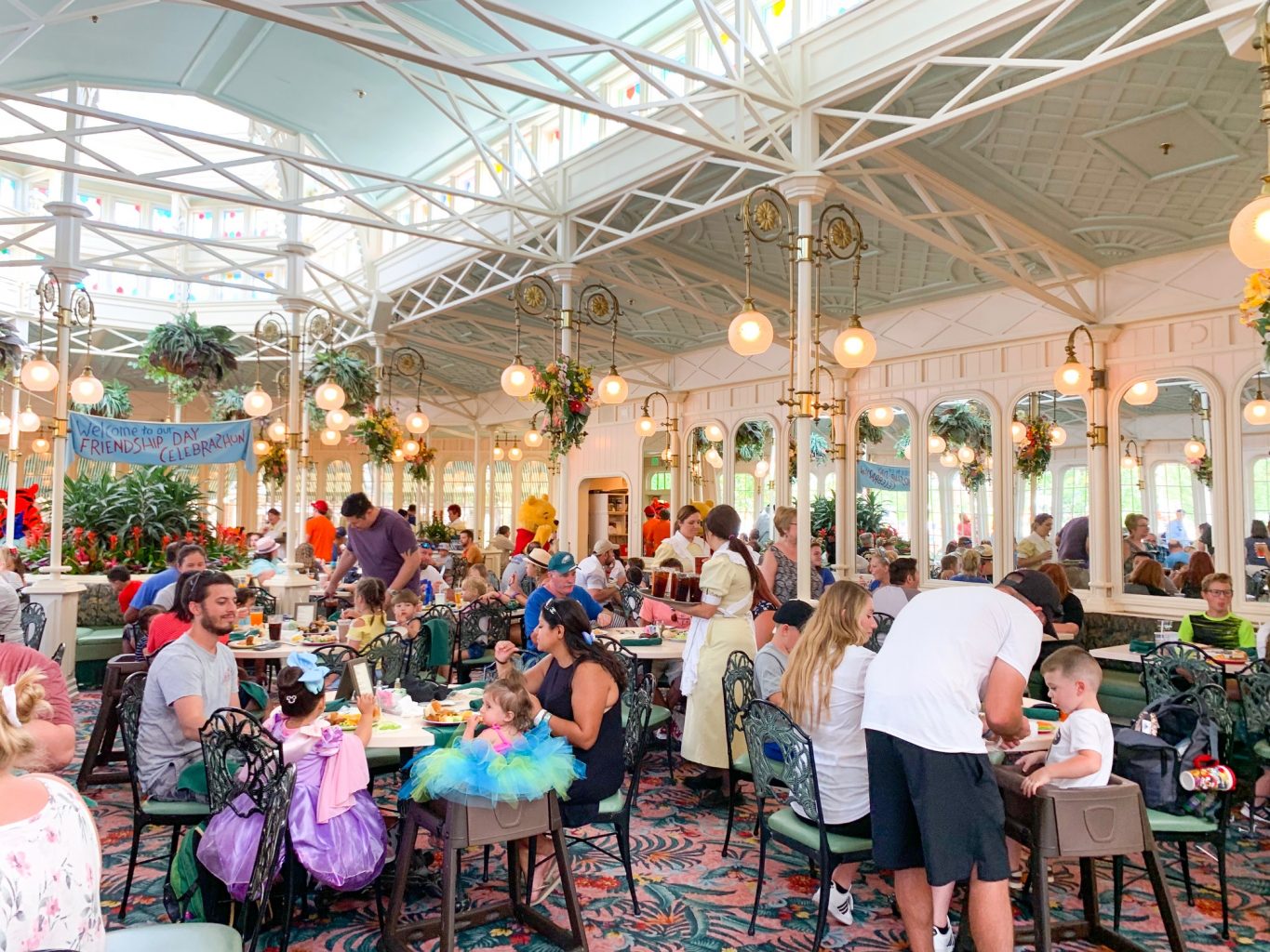 people eating at white and gold restaurant with winnie the pooh best disney world restaurants