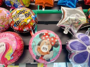 Minnie balloon surrounded by other non-Disney balloons