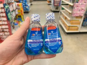 hand holding two pack of Crest travel-size mouth wash