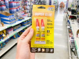 hand holding two-pack of super glue Dollar Tree Disney