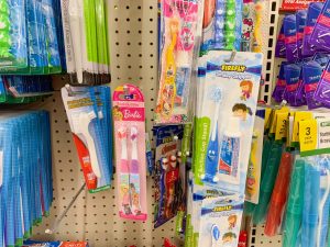 shelf full of Disney-themed toothbrushes for kids