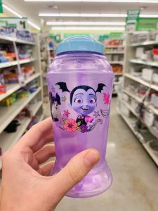 hand holding purple Vampirina reusable water bottle