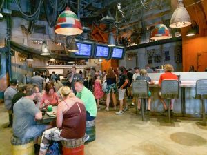 people gathered in futuristic yet rustic dining area hollywood studios quick service