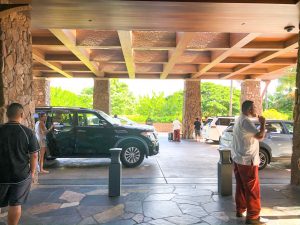 car drop off air with wooden ceiling and lava rock pillars