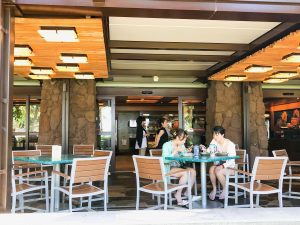 outdoor seating area with two girls sitting at one of the tables