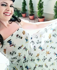 woman wearing white dress with all of the original Disney characters