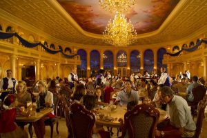 elegant, golden dining area with painted ceiling