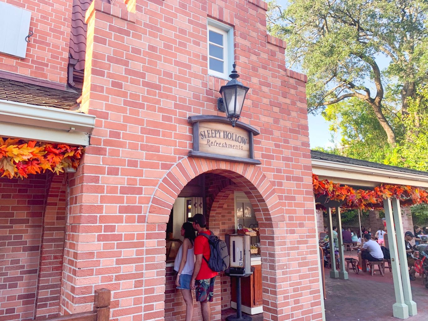 The charming brick exterior of Sleepy Hollow Refreshments, one of the Magic Kingdom quick service restaurants