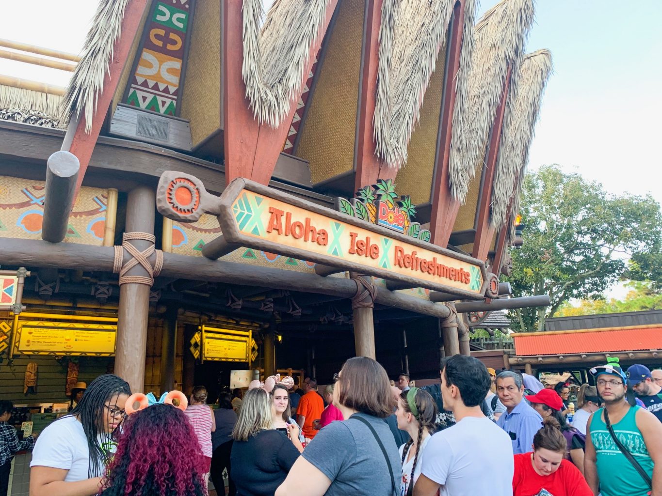 The Polynesian inspired exterior of Aloha Isles calls crowds for dole whip at one of the best Magic Kingdom Restaurants.