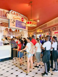 people standing in line to order in bright red room