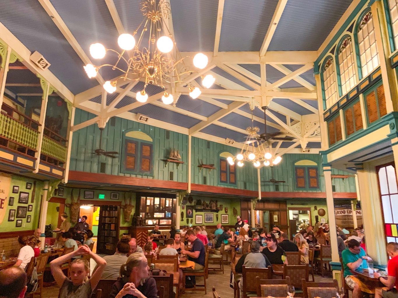 The rustic western dining area of Skippers Canteen is green, white, and brown, and in this photo, booths and tables are filled to capacity. No wonder this is one of the best restaurants in Magic Kingdom!