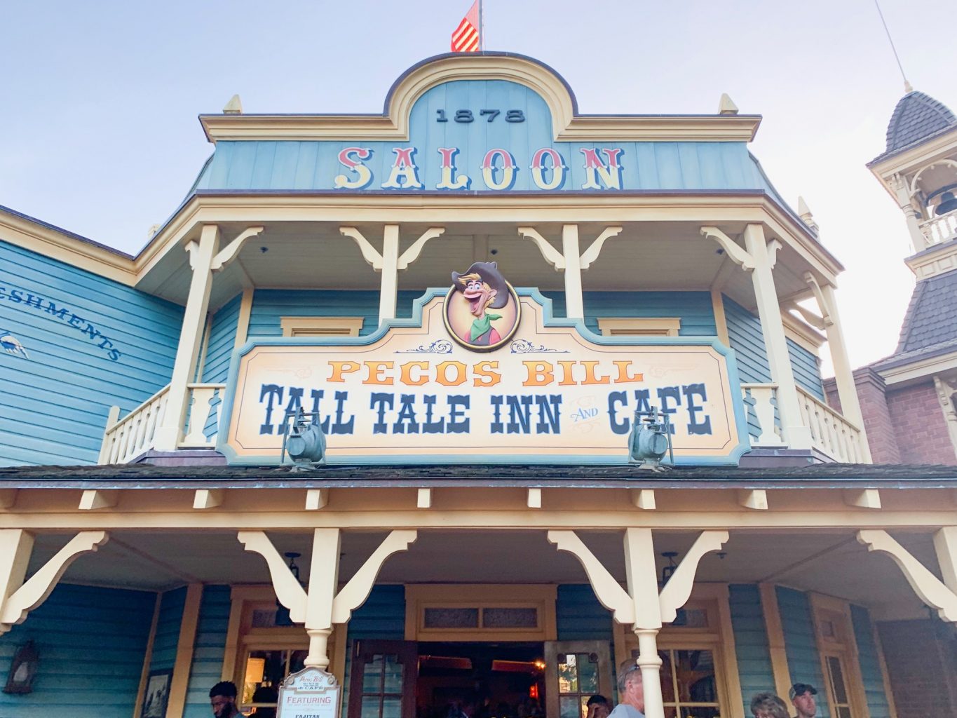 The light blue country-style exterior of Pecos Bill is one of the best Magic Kingdom Restaurants, known for its Mexican food and family friendliness. 