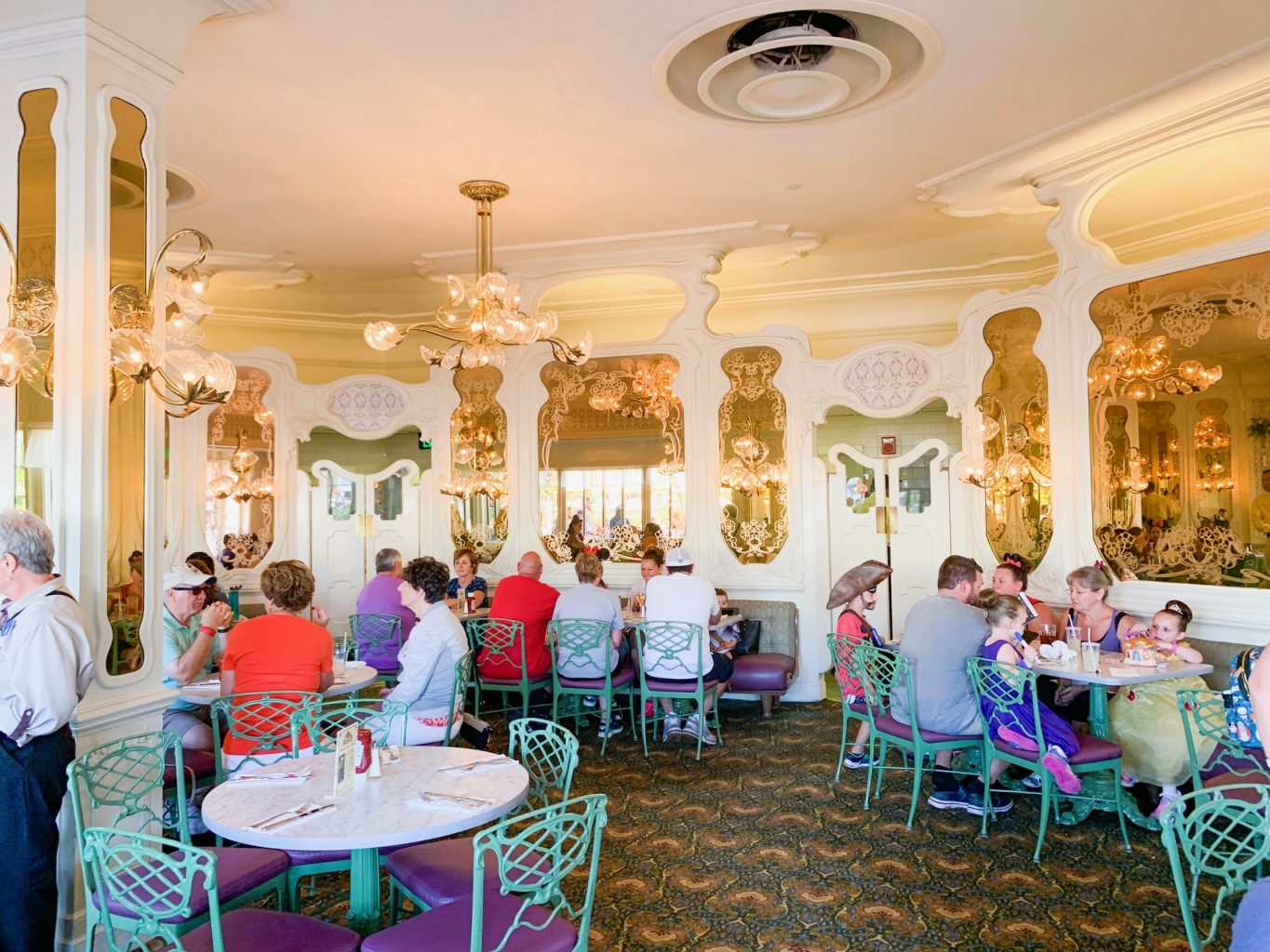 The antique white and gold interior with green chairs of the Plaza Restaurant show how dated this location is, which makes it not one of the best Magic Kingdom Restaurants.