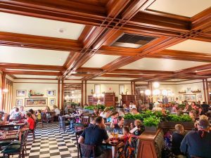 indoor room with wooden beams and outdoor plants Magic Kingdom Restaurants