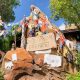 battered expedition everest sign surrounded by torn cloth pieces