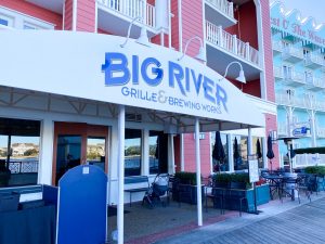 red building with blue and white awning for Big River Disney Boardwalk restaurant