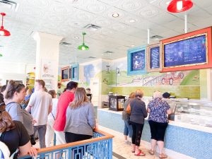 bustling ice cream parlor with a long line Disney Boardwalk