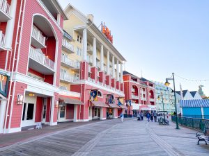 red, yellow, and light blue buildings lining a wooden promenade Disney Boardwalk