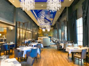 elegant restaurant interior with chandeliers and white table cloths Disney Boardwalk