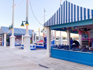 waterfront blue and white striped booths with boardwalk games