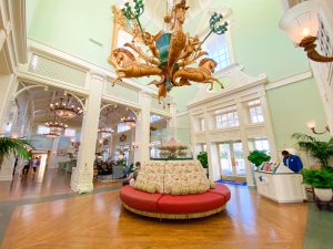 vintage style interior with golden horse chandelier and rounded couch Disney transportation