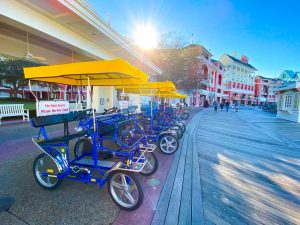 line of surrey bikes along the Disney Boardwalk