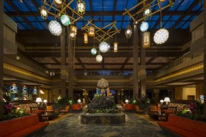 island-inspired lobby with tiki statue holding leis