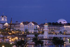exterior of white and blue building at dusk Disney deluxe resorts