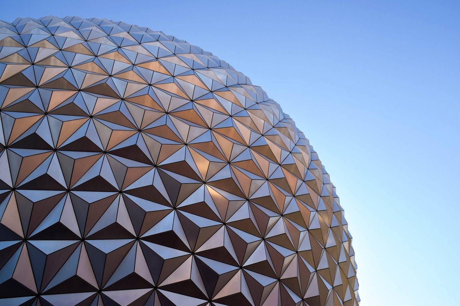 up close picture of silver geodesic sphere against the sky