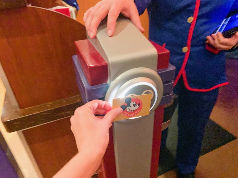 hand scanning yellow pass holder card disney on a budget