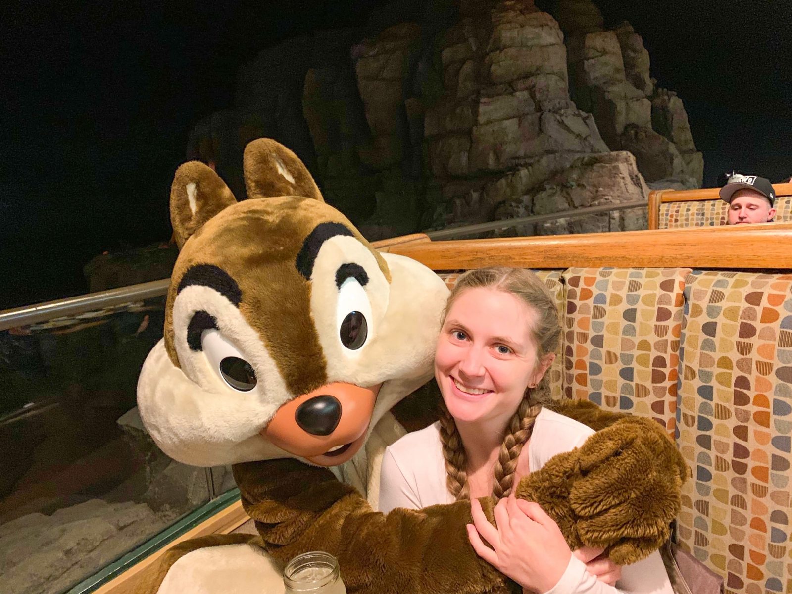 woman hugging chip character dining at Disney