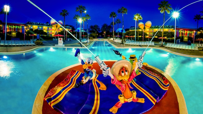 three caballeros bird statues in front of pool at All-Star music resort