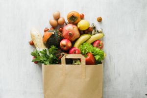 fruit and vegetables fallingout of grocery bag